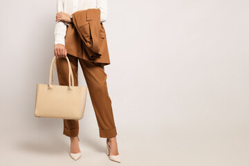 Young woman with stylish bag on white background, closeup