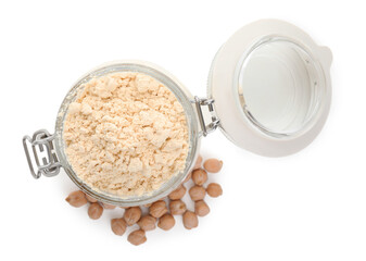 Chickpea flour in glass jar and seeds isolated on white, top view
