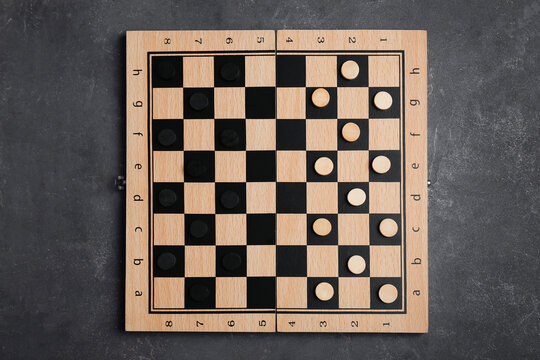 Wooden Checkerboard With Game Pieces On Grey Table, Top View