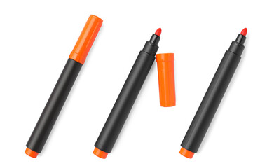 Set of bright orange markers on white background, top view. School stationery