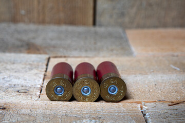 three 12 gauge shotgun shells in a row, made in USA stamped on brass