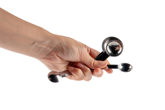 Hand and measuring spoon on transparent background