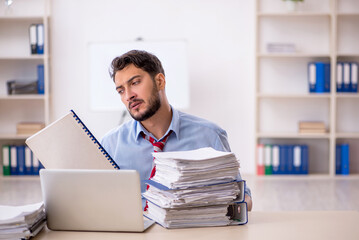 Young male employee working in the office