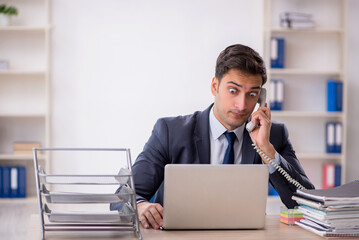 Fototapeta premium Young male employee working in the office