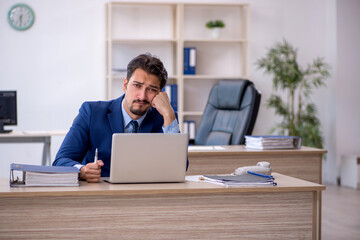 Young male employee working in the office
