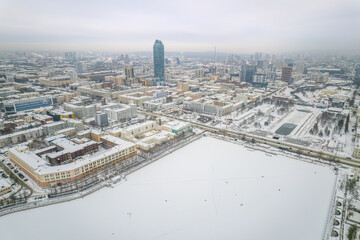 Fototapeta premium Embankment of the central pond and Plotinka in Yekaterinburg at winter sunset. The historic center of the city of Yekaterinburg, Russia, Aerial View