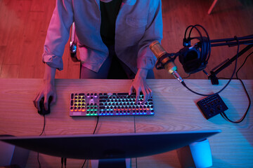 Teenage blogger with professional microphone recording podcast at her desk