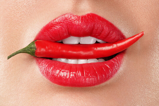 Woman lips and chili peppers. The concept of sexuality passion desire.