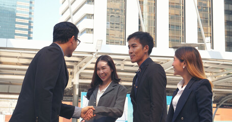 Fototapeta premium Diversity Business Partner meeting trust in teamwork and partnership businessman, businesswoman talking together in modern city. Asian coworker team meeting with Business People Working Together Team