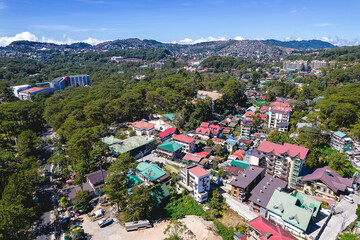 Baguio City, Philippines - Aerial of hotels and other lodging with Downtown Baguio in the distance.