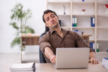 Young attractive employee sitting in the office