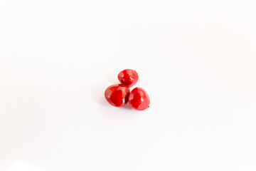 Ayurvedic plant Adenathera pavonina red seeds isolated on a white background