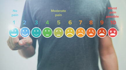 Man touching of pain measurement scale colorful icon virtual screen interface, emotions from happy...