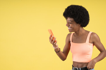 Pretty young afro woman making a video call with her cell phone