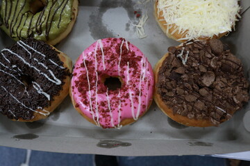 Donuts with various flavors, chocolate, cheese, teramisu, strawberries, nuts and avocado
