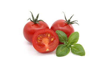 Tomato and green basil leaves isolated on white