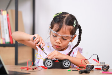 Asian little girl students learn at home by coding robot cars in STEM, STEAM, mathematics...