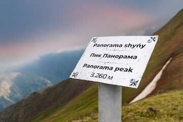 Signboard with indication of height above sea level on top of Panorama peak in Almaty mountains of Kazakhstan nature.