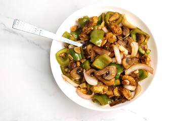 Fresh stir fried or sauteed vegetables. broccoli, zucchini, green and red peppers, mushrooms, onions, baby corn. colorful veggies in a white plate. Weightloss journey. Fitness concept. Healthy life.