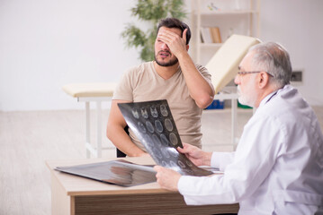 Young male patient visiting old male doctor radiologist