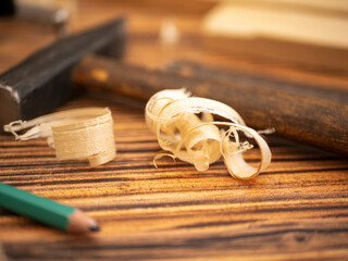 Carpentry and a hammer. Atmospheric composition about carpentry with planks, shavings, and joinery...