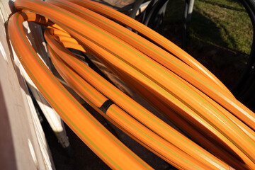 Rolled up orange colored cable for fiber glass internet expansion in a construction site