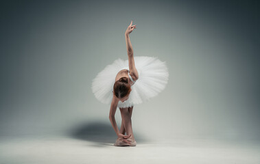 young ballerina girl makes a bow. on a white background. © Maestro7
