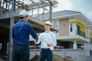 Engineers man handshake at construction site. Worker and contruction manager shaking hands while working for teamwork.