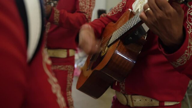 mariachi guitar close up red outfits mexican party