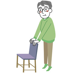 椅子につかまってかかと上げの運動をするシニア男性