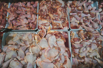 Photo of raw chicken portions for cooking and barbecuing with skinless breasts and diced strips for...
