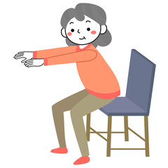 椅子を使ってスクワットをするシニア女性