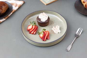 chocolate fondant with strawberries and cream 