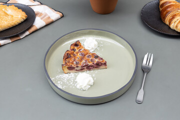 Clafoutis with cream on a plate