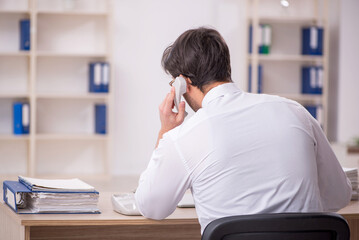 Young male employee working in the office