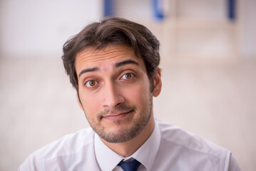Young male employee working in the office