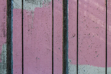 Close-up of a   pink    wall  painted a very long time and the paint peeled off.  Scary background with smudges of paint