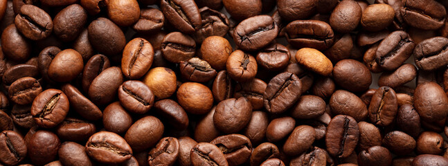 Grains of black coffee as a background.