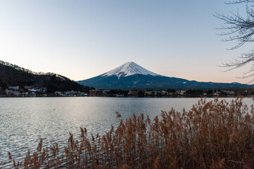 Mount Fuji on a bright winter morning, as seen from across lake Kawaguchi, and the nearby town of Kawaguchiko.