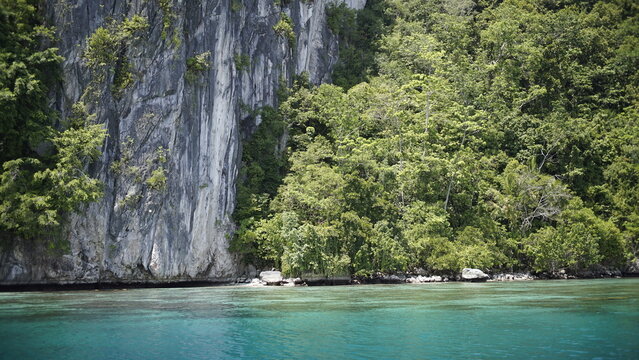 Magnificent rock cliffs with beautiful blue sea in North seram island saleman village