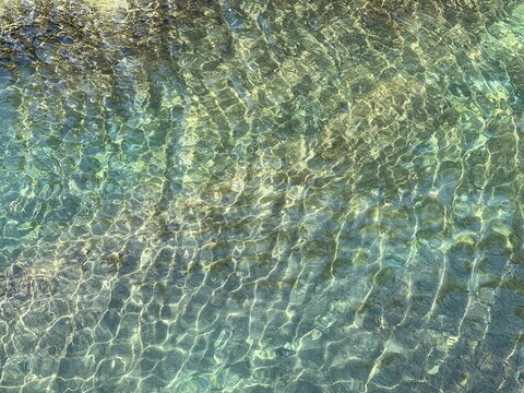 Sea water clear turquoise surface, shiny ocean waters, beautiful aqua seascape.