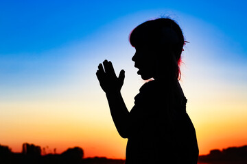 Fototapeta premium Silhouette of man praying at sunset background