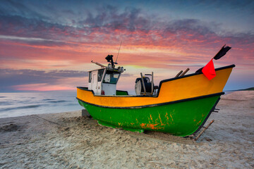 Naklejka na ściany i meble Fishing boat on the Baltic Sea beach in Jantar. Poland
