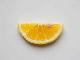 A slice of lemon on a white background. Close-up