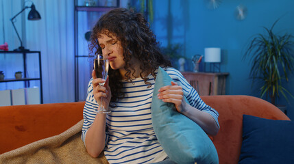 Sad woman brunette sits at home looks pensive of unrequited love, suffers from unfair situation,...