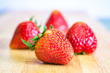 Strawberries placed on a wooden tray with soft background , selective focus