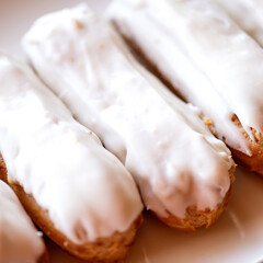 Fototapeta na wymiar Eclairs with white fudge. French dessert. Custard cake with cream. Sweet pastry. Big plan. Soft focus. View from above. 