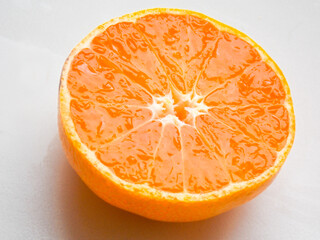 Orange on a white background. Cut in half