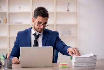 Young male employee working in the office