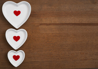 white and red hearts on a wooden background.  Love and relationships concept. Copy space